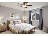 Light and bright bedroom featuring ceiling fan, neutral walls, and a comfortable bed with stylish pillows at 3312 Meadow Ave, Broomfield, CO 80020