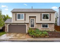Charming two-story home with a brick facade and a well-maintained front yard in a suburban neighborhood at 3312 Meadow Ave, Broomfield, CO 80020