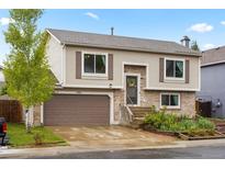 Charming two-story home with a two car garage, brick accents, and well maintained landscaping at 3312 Meadow Ave, Broomfield, CO 80020