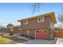 Charming two-story home with brick accents, complemented by a well-maintained yard and inviting curb appeal at 3646 E Fair Pl, Centennial, CO 80121