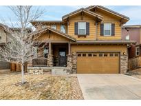 Inviting two-story home with a charming front porch and a two-car garage at 10360 Sierra Ridge Ln, Parker, CO 80134