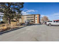 Building exterior showing parking and landscaping at 300 S Clinton St # 10C, Denver, CO 80247