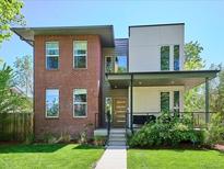 Modern two-story home with a mix of brick and siding, complemented by a well-manicured lawn at 2508 S Pennsylvania St, Denver, CO 80210