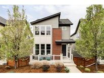Charming two-story home with a modern design, landscaped yard, and inviting front porch at 8917 Yates Dr, Westminster, CO 80031