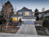 Charming two-story home with a well-manicured lawn and inviting curb appeal at 4930 Laurelglen Ln, Highlands Ranch, CO 80130