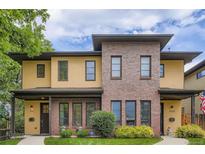 Beautiful two-story townhouse with a combination of brick and tan siding, plus a well-manicured lawn at 1916 S Elati St, Denver, CO 80223