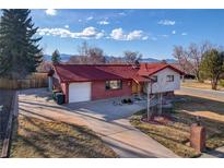 Charming single-story home featuring a red roof and brick accents with a spacious driveway and mountain views at 3885 Hoyt St, Wheat Ridge, CO 80033