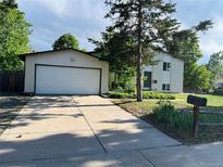 Charming home featuring a large driveway leading to a two-car garage at 15908 E Flora Pl, Aurora, CO 80013