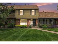 Charming townhome with a well-manicured lawn and inviting brick facade at 9031 E Amherst Dr # D, Denver, CO 80231