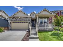 Charming single Gathering home with a stone facade, two car garage, and a cozy front porch with beautiful landscaping at 16578 E 111Th Pl, Commerce City, CO 80022
