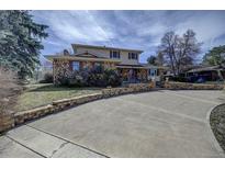 Two-story house with a large driveway and landscaping at 7759 Lee St, Arvada, CO 80005