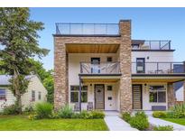 Modern townhouse showcasing a stone facade, balconies, and a rooftop deck at 4455 Tejon St, Denver, CO 80211