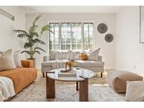 Bright living room with large window, comfortable seating, and stylish decor providing a cozy and inviting atmosphere at 1410 Vine St # 3, Denver, CO 80206
