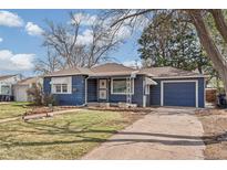 Blue home with a well-manicured lawn, a single car garage and sidewalk leading to the front door at 2718 S Hazel Ct, Denver, CO 80236