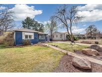 Charming home with well-maintained lawn, landscaping, and a pathway leading to the front door at 2718 S Hazel Ct, Denver, CO 80236