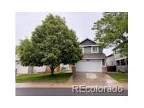 Charming two-story home with a well-manicured lawn and mature shade tree at 6973 Summerset Ave, Longmont, CO 80504