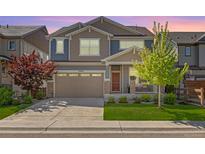 Charming two-story home with a two-car garage and a well-manicured lawn at 15608 E Otero Cir, Centennial, CO 80112
