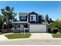Charming two-story home with a well-manicured lawn and a two-car garage, perfect for Gathering living at 16840 Hoot Owl Ct, Parker, CO 80134