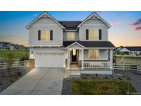 Charming two-story home featuring a spacious two-car garage, inviting front porch, and professionally landscaped front yard at 7137 S Vandriver Way, Aurora, CO 80016