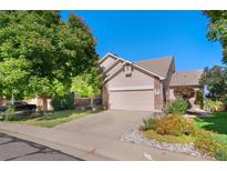 Charming home with a well-manicured lawn, beautiful flowering plants, and a two-car garage at 3337 W 113Th Ave, Westminster, CO 80031