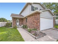 Charming two-story home with brick accents and well-maintained front yard at 9630 W 104Th Ave, Broomfield, CO 80021