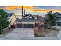 Beautiful two-story home featuring a three-car garage and a well-maintained lawn at 7463 Soapstone Way, Castle Rock, CO 80108