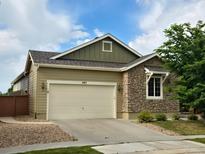 Charming home with a two-car garage, stone accents, and a well-maintained lawn at 483 W 172Nd Pl, Broomfield, CO 80023