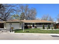 Charming single-story home featuring a well-manicured lawn, two-car garage, and inviting curb appeal at 3281 Vivian Dr, Wheat Ridge, CO 80033