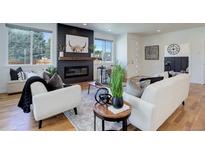 Bright living room features a fireplace and hardwood floors at 5601 E Iowa Ave, Denver, CO 80224