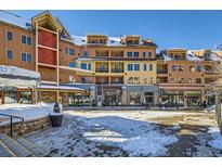 Attractive multi-story building with shops, snow and blue skies on a sunny day at 505 S Main St # 1313, Breckenridge, CO 80424