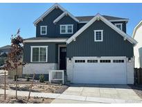Beautiful two-story home with a two car garage, light stone accents, and a well-manicured lawn at 17719 Prairie Peak Trl, Parker, CO 80134