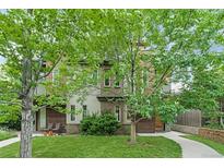 Charming multi-level townhouse with a well-maintained front yard and beautiful, mature shade trees at 4544 Utica St, Denver, CO 80212