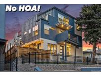 Striking modern home with a multi-level design, private balconies, and inviting outdoor lighting at 1259 Perry St, Denver, CO 80204