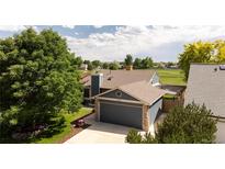 Well-maintained home featuring a two-car garage, mature trees and landscaped yard at 11381 Jay St, Westminster, CO 80020