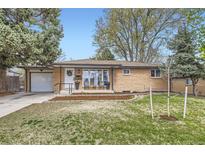 Charming brick home with a well-manicured front yard, attached garage, and a welcoming entrance at 7080 Beach St, Westminster, CO 80030