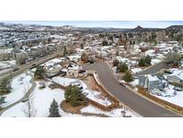 Panoramic aerial view of a quiet neighborhood with snow-dusted houses and mountain views at 1206 Baldwin Park Cir, Castle Rock, CO 80104