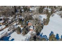 Aerial view of a house with large backyard in snowy landscape at 3750 S Ogden St, Englewood, CO 80113