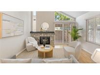 Cozy living room with stone fireplace, natural light, and stylish decor at 2910 S Racine St, Aurora, CO 80014