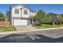 Charming two-story home with a well-maintained lawn and attached two-car garage at 1145 S Boston St, Denver, CO 80247