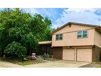 Charming two-story home with a brick facade and an attached two-car garage at 6411 W 82Nd Dr, Arvada, CO 80003