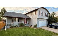 Charming two-story home with well-manicured lawn, inviting porch, and attached garage at 5255 S Waco St, Centennial, CO 80015