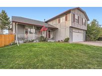 Charming two-story home with well-manicured lawn and beautiful landscaping at 5255 S Waco St, Centennial, CO 80015