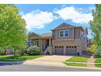 Two-story house with attached garage, landscaped lawn, and mature trees at 14307 Waterside Ln, Broomfield, CO 80023