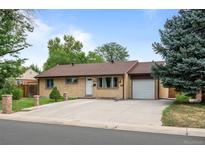 Charming single-story home features a well-maintained lawn and a large driveway at 1470 S Yates St, Denver, CO 80219