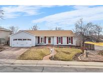 Charming single-Gathering home with a well-manicured lawn and a cozy front porch at 16308 E Wyoming Dr, Aurora, CO 80017