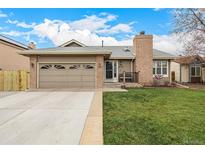Charming single-Gathering home with a well-maintained lawn and a brick chimney at 3170 S Princess Cir, Broomfield, CO 80020