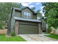Charming two-story home with a well-manicured lawn and attached two-car garage at 5370 S Union Way, Littleton, CO 80127