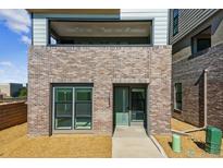 Modern home with brick facade, balcony, and clean architectural lines at 11493 E Briarwood Cir, Centennial, CO 80112