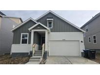 Charming two-story home featuring a two-car garage, landscaped yard, and inviting front entrance at 16478 W 92Nd Pl, Arvada, CO 80007
