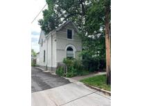 Charming two-story home with lush landscaping and architectural details, near a sidewalk and alleyway at 819 27Th St, Denver, CO 80205